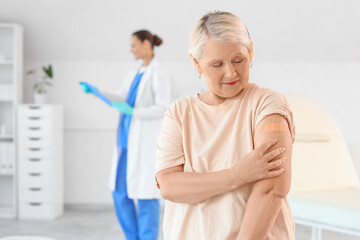Senior woman with medical patch after vaccination in clinic
