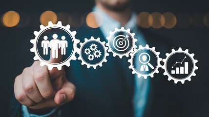 Businessman touching virtual gears with teamwork and goal setting icons representing business development and successful strategy