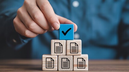 Hand placing check mark cube on a pyramid of document cubes illustrating process completion and verification