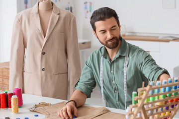 Male tailor working at table in atelier