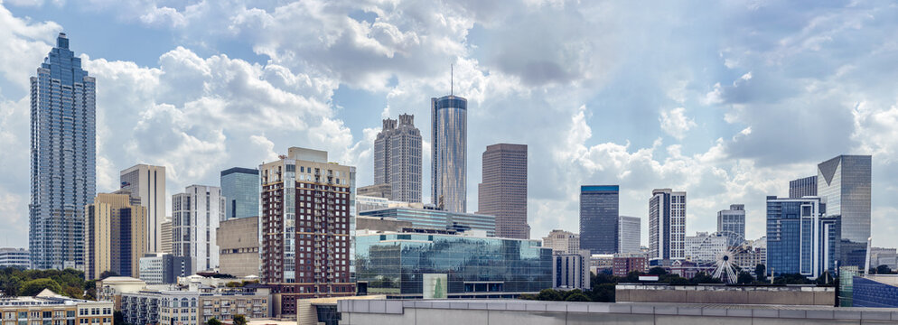 View of the Midtown, Downtown Atlanta Skyline showing several prominent buildings, and hotels under a cloudy  sky.