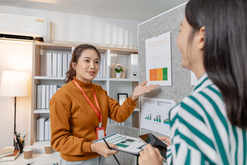 Fototapeta premium Colleagues working together in a startup meeting, focusing on creative solutions and entrepreneurial strategies that drive innovation, progress, and long term business growth.
