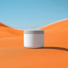 White cosmetic jar on orange desert sand