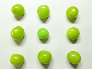Nine green grapes against a simple white background A visually appealing display for freshness
