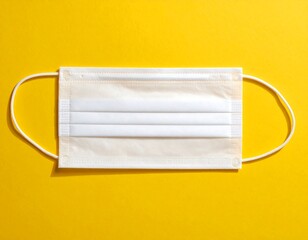 Single Protective Face Mask on Vivid Yellow Background
