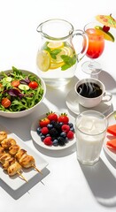 Healthy breakfast spread with various foods and drinks arranged on a white surface table top view