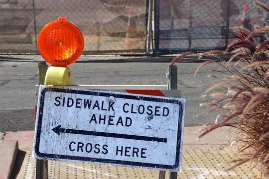 SIDEWALK CLOSED AHEAD - CROSS HERE sign