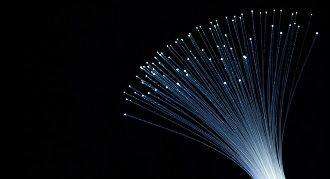 Glowing fiber-optic strands on black background: high-speed internet, bandwidth and digital connectivity for modern telecommunications