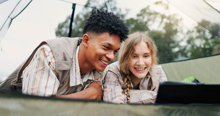 Happy, couple and relax in tent with laptop for research, watching movies and bonding together. Smile, people and rest with pc on camping getaway, browsing internet and online entertainment in nature