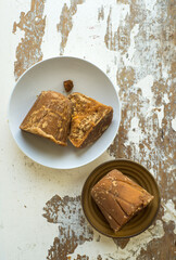 Indian Jaggary or Sugarcane molasses solid cakes placed in bowl. Organic Gul or jaggery - A healthy alternative to sugar.