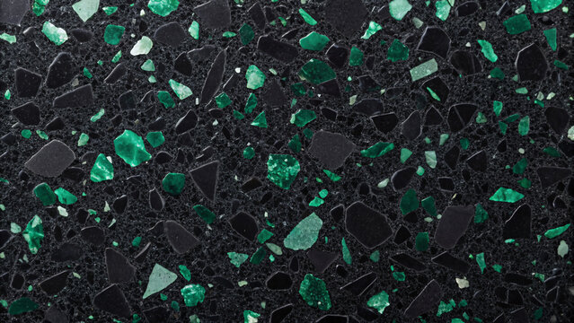 Dark terrazzo flooring with emerald green, mint, and forest green stone chips distributed across black base, creating striking verdant speckled surface. - Powered by Adobe