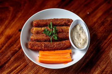 Delicious breaded mozzarella cheese sticks stack with hand 