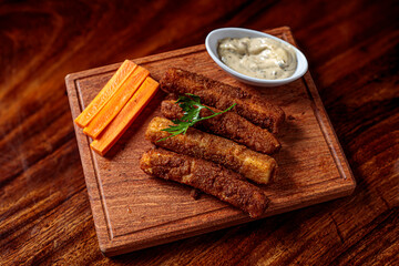 Delicious breaded mozzarella cheese sticks stack with hand 