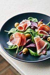 Delicious salad with prosciutto and olives modern kitchen food photography indoor close-up healthy eating