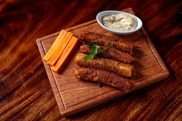 Delicious breaded mozzarella cheese sticks stack with hand 