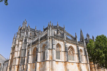 Fototapeta premium The stunning Manueline arcades and Gothic tracery of the Royal Cloister (Claustro Real) at Batalha Monastery. Peaceful Portuguese heritage.