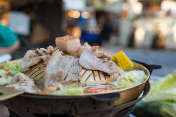 Thai barbecue grill pork on hot pan buffet. Thai called Moo gata.