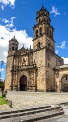 Obraz premium Spanish colonial church, stone facade, bell tower, sunny day