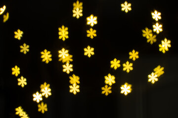 Bright Golden Snowflakes Sparkling in a Dark Background Create a Festive Mood for the Holiday Season