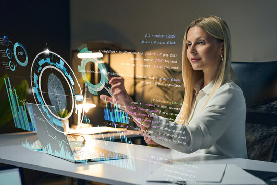 Female Tech Professional Analyzing Futuristic Data Visualizations With Holographic UI Interfaces In Brightly Lit Office