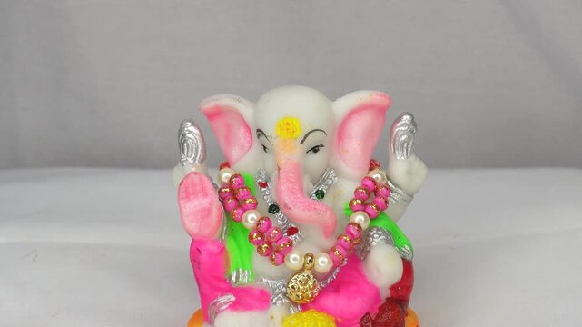 An idol of an Indian god, Lord Ganesha on white background. Lord Ganpati bappa, Happy Ganesh Chaturthi. Copy space