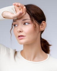 Fototapeta premium Tired Fitness Woman Resting After Workout With Hand On Forehead