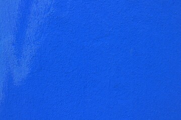 Blue painted wall texture. Minimal background for graphic design, urban architecture detail, gritty plaster texture backdrop and high-resolution abstract surface