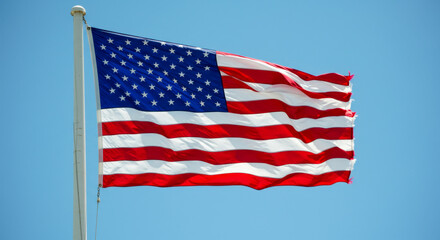 Obraz premium United States Flag Waving Over Green Hills Under Sunny Sky