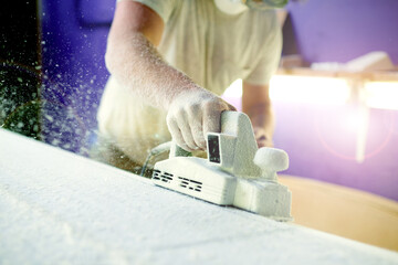 Hands, workshop and foam with sanding, surfboard and creativity for skills, talent and hobby. Tools, artist and entrepreneur with craftsman for design manufacturing and custom work for artisan craft