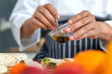 chef make tortilla wrap vegetable salad slice by knife on cutting board and mix sour salad dressing in small bowl glass with wine and olive oil. tortillas wrap vegetable and juicy liquid sour dressing