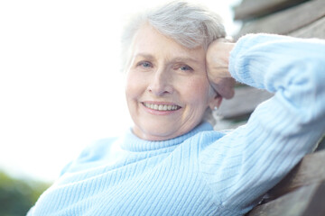Portrait, smile and senior woman in backyard for peace, calm morning and stress free on swing. Happy, elderly person and relax outdoor on retirement, fresh air and wellness for weekend break at house