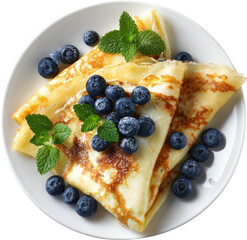 Stacked crepes topped with blueberries and mint