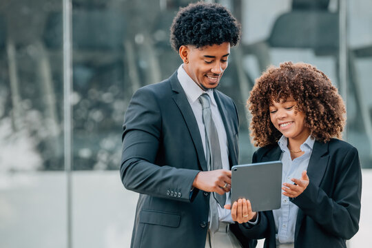 young business couple analyzing with mobile devices