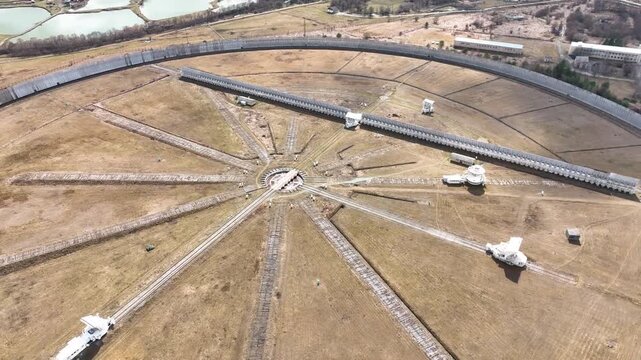 Karachay Cherkessia, Russia - September 12, 2024: A close up top down aerial view of the gigantic circular RATAN 600 radio telescope, focusing on the central receiver structure and the network of radi