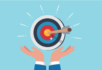 Goal or target, focus and concentration to achieve success, purpose or objective, aiming at target bullseye, accuracy, challenge and aspiration, businessman hand hold target with arrow hit bullseye.