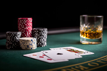 Playing cards featuring spade and face card are laid on a black table with poker chips and a glass of whiskey, creating a vibrant gambling atmosphere