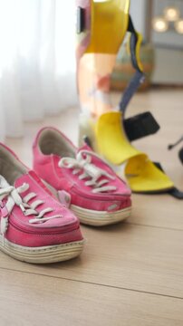 Orthopedic AFO and shoes on a wooden floor 