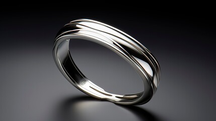 A photo of a sleek silver open cuff.