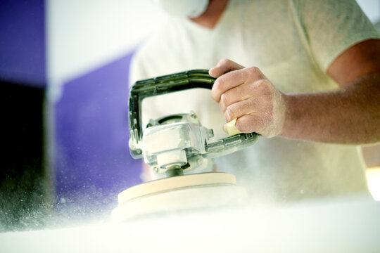 Man, workshop and foam with sanding, surfboard and tools for skills, talent and hobby. Creative, artist and entrepreneur with craftsman for design manufacturing and custom work for artisan craft