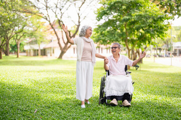 Senior, couple and people with disability in park for fresh air, walking and enjoyment of retirement or wellness with love. Man, woman and outdoor in garden for bonding, together and wheelchair.