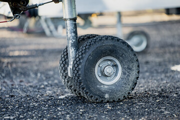 Lift trailer front support wheel with rugged tire and steel strut construction, designed for...