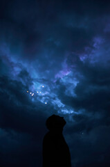 Strange lights in the cloudy night sky—eerie and dramatic.