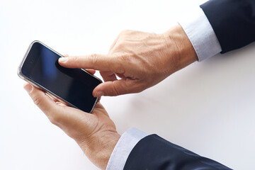 Scroll, hands and businessman in studio with phone screen for professional update, message and news. Online, employee and person with tech, internet research and mobile app on white background.