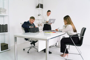 Business meeting in modern office with professionals collaborating on project tasks