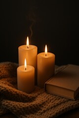 Cozy hygge evening with lit candles and a book.