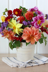 Colorful dahlia flowers bouquet in a white vase