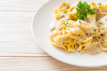 tortellini pasta with mushroom cream sauce and cheese