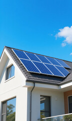 Fototapeta premium Bright residential home rooftop adorned with modern solar panels under a clear blue sky, symbolizing clean energy and sustainability
