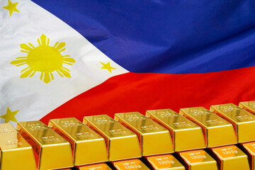 Row of gold bars on the Philippines flag background. Concept of gold reserve and gold fund of Philippines