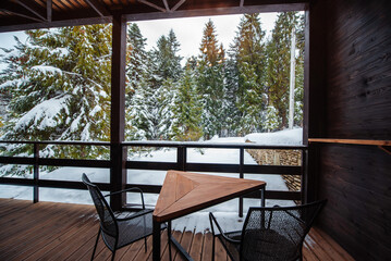 Snowy Forest View from Wooden Balcony